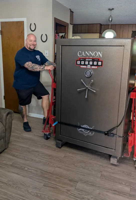 Photo of Travis moving a large safe